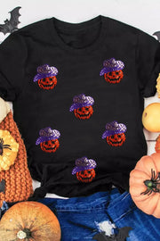 Black t-shirt with scattered sequin jack-o'-lanterns wearing purple hats.