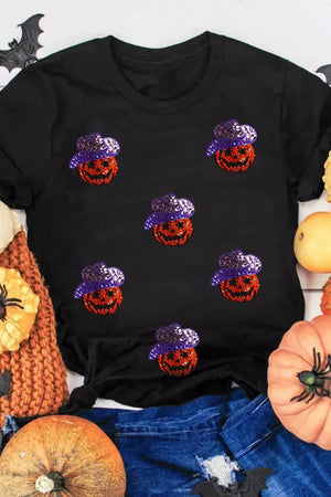 Black t-shirt with scattered sequin jack-o'-lanterns wearing purple hats.