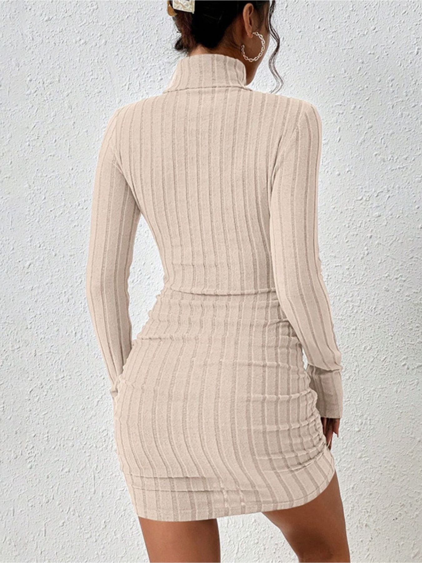 Ribbed turtleneck bodycon mini dress in apricot with long sleeves and a form-fitting silhouette.