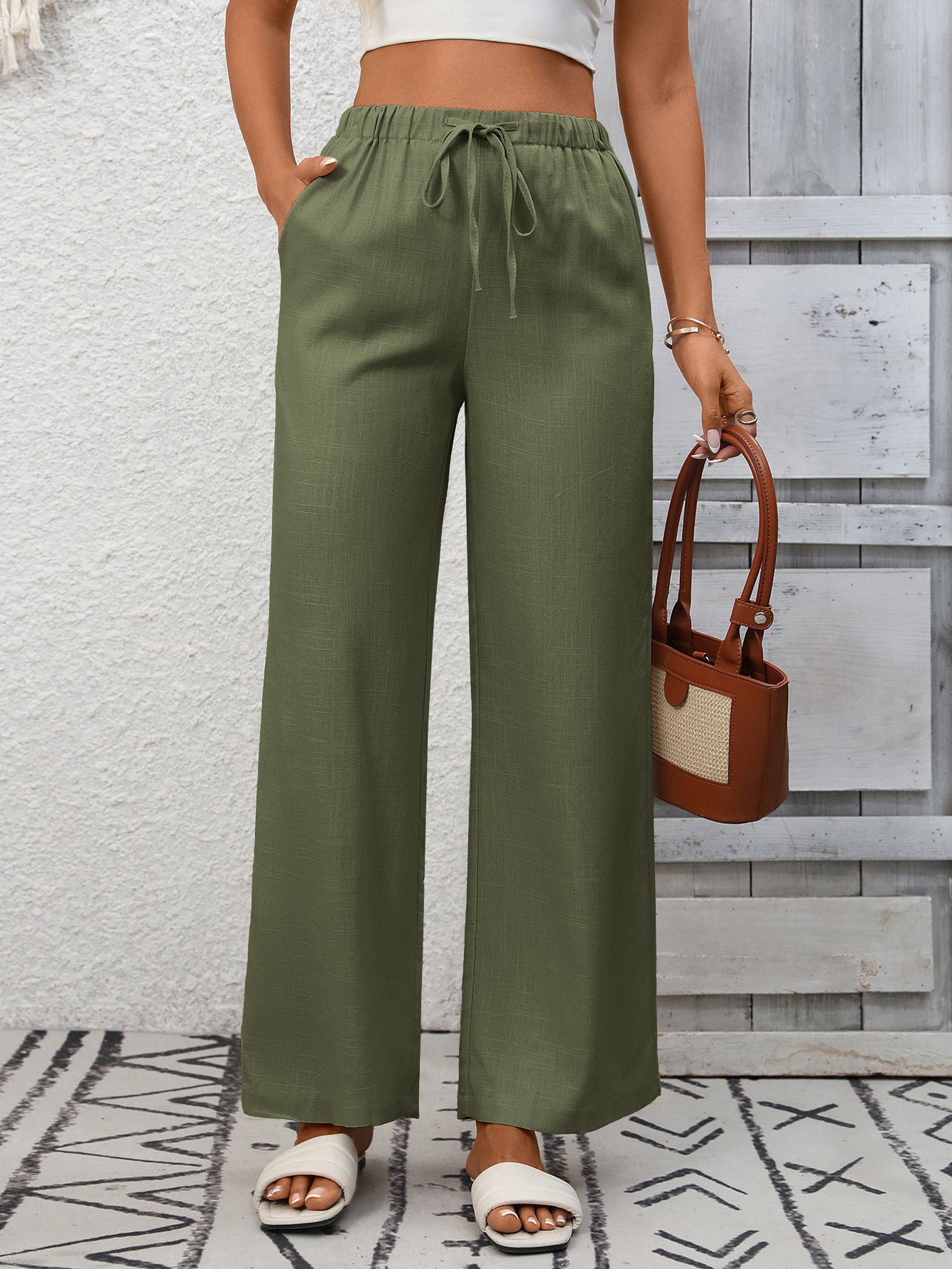 Army green high-waist wide-leg pants with drawstring and pockets.