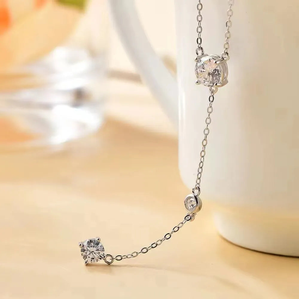 Silver lariat necklace with three sparkling moissanite drop details.