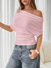 Pink ruched off-shoulder knit t-shirt with draped neckline and short sleeves.