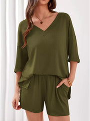 Sage green ribbed V-neck loungewear set with cuffed sleeves and drawstring shorts with pockets.