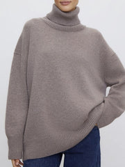 Relaxed turtleneck sweater in acrylic knit, featuring sculptural sleeves and a ribbed hem.