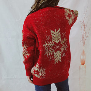 Red acrylic knit sweater with gold snowflake embellishments and tinsel detail.