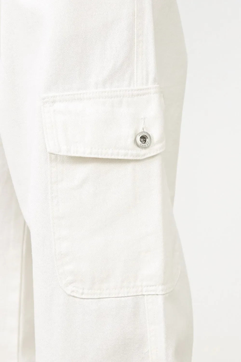 White 100% cotton wide leg cargo pants with pleated detail and buttoned flap pocket.