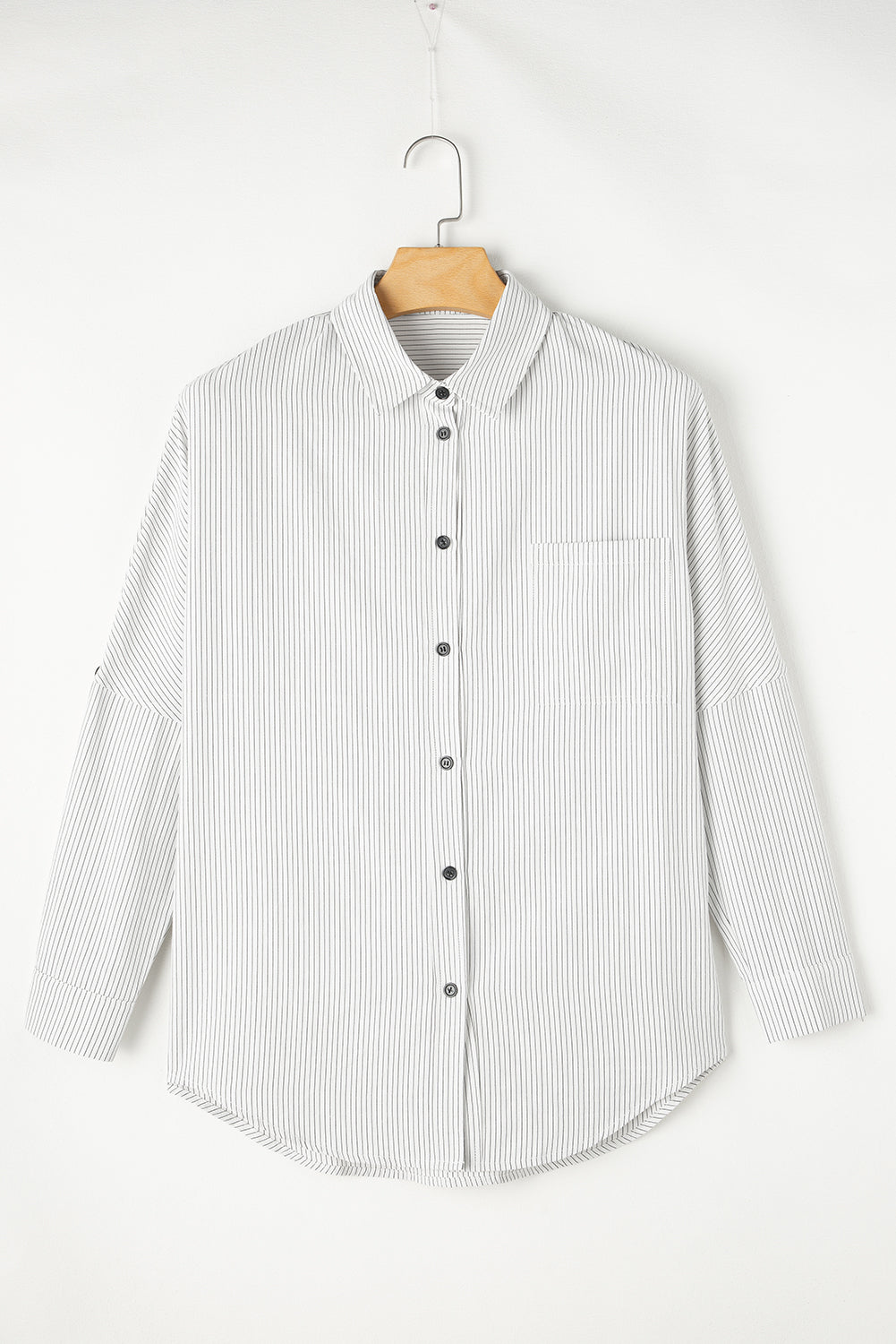 Relaxed white button-down shirt with vertical pinstripes and a chest pocket.