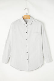 Relaxed white button-down shirt with vertical pinstripes and a chest pocket.