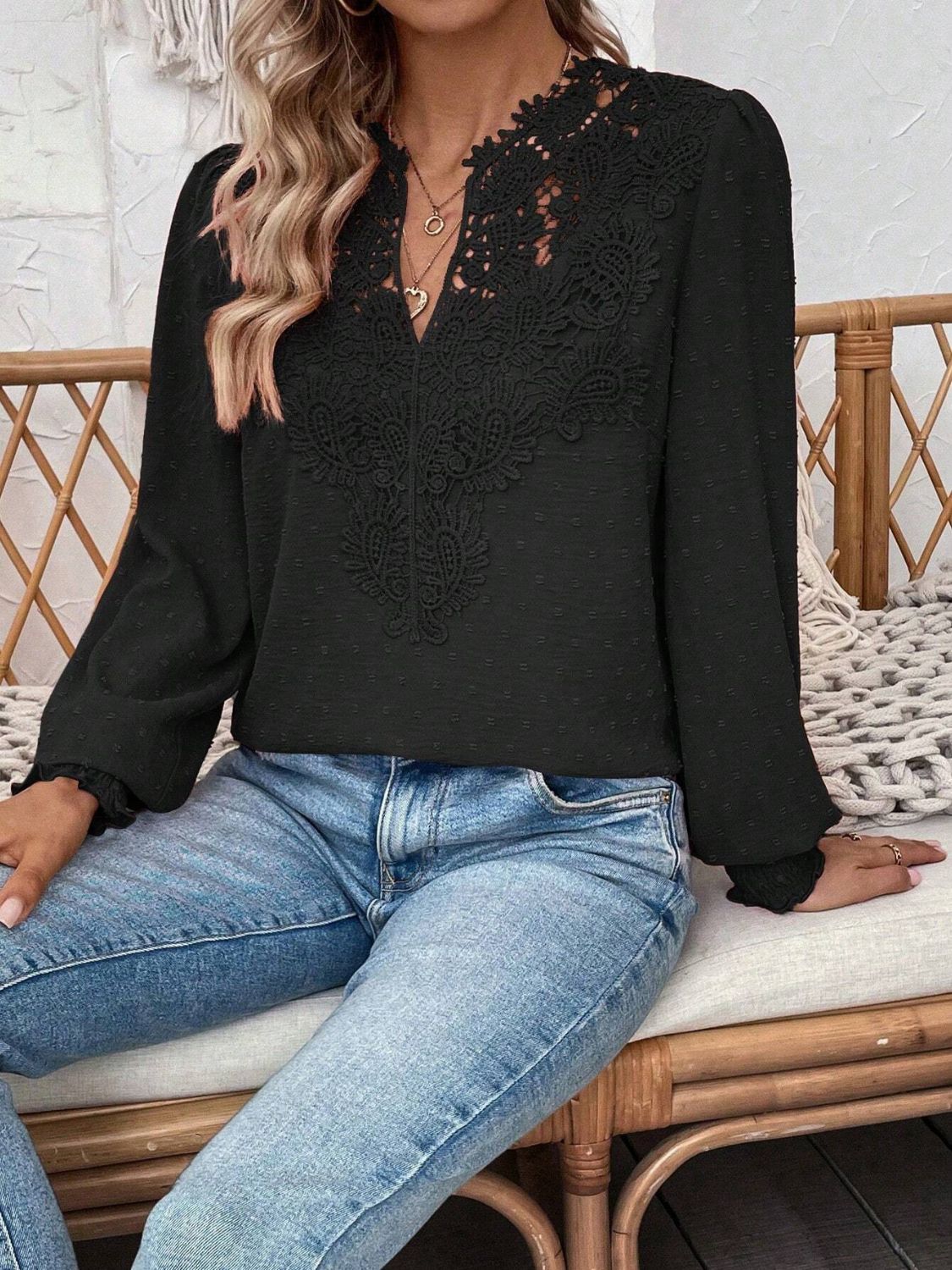 Black embroidered yoke blouse with puff sleeves and textured fabric