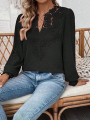 Black embroidered yoke blouse with puff sleeves and textured fabric