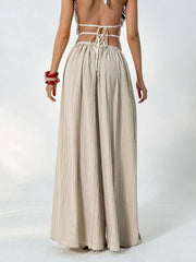 Textured wide-leg maternity pants in beige with a gathered waist and drawstring detail.