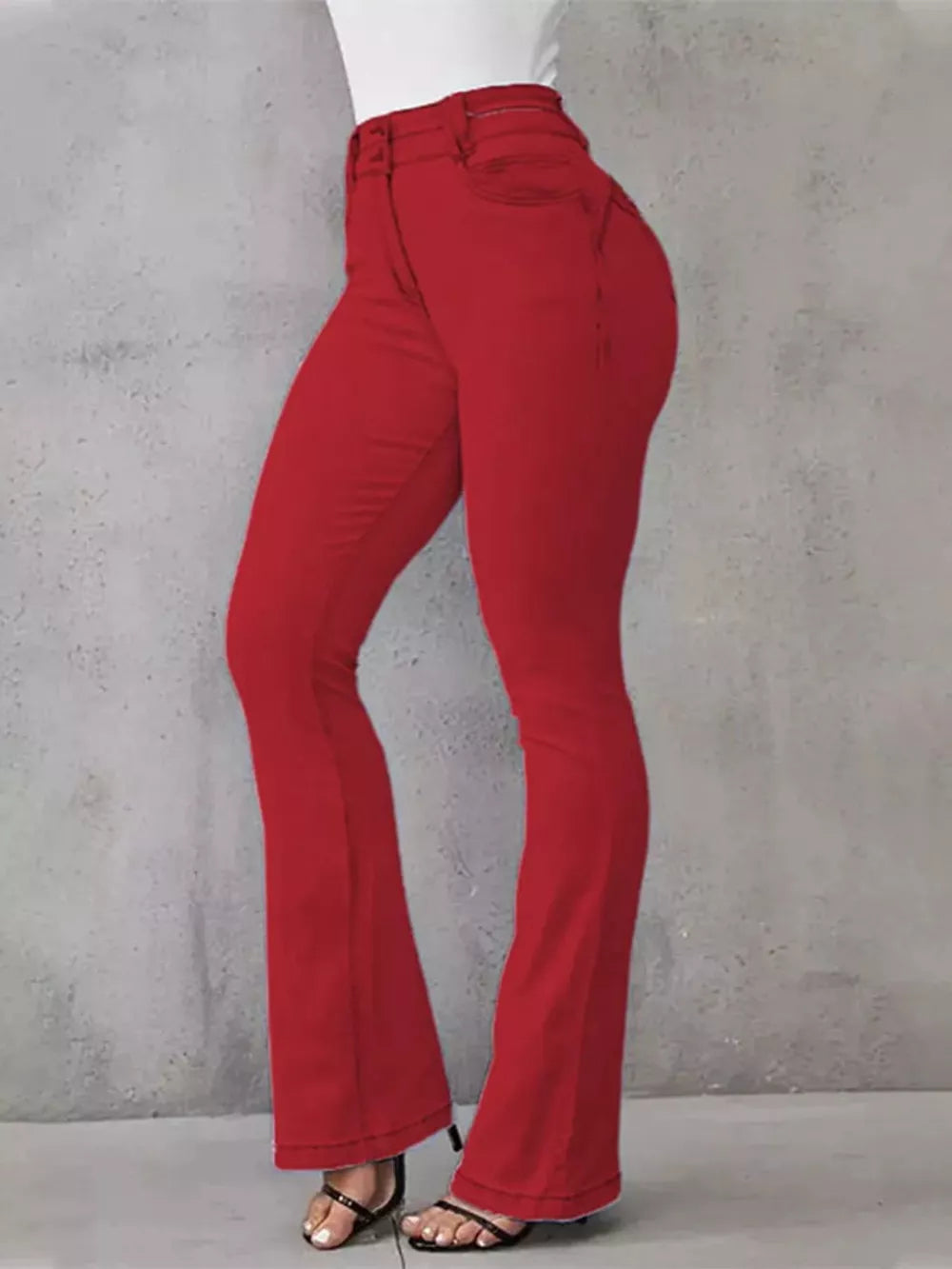 Red high-waisted flare jeans with buttoned closure and cotton spandex material.