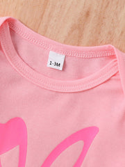 Blush pink baby bodysuit with bunny ear graphic and size tag.