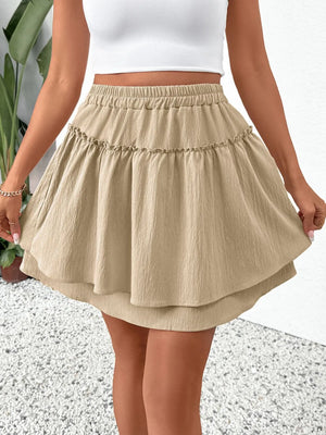 Tiered ruffle mini skirt in tan with elastic waist, casual boho style