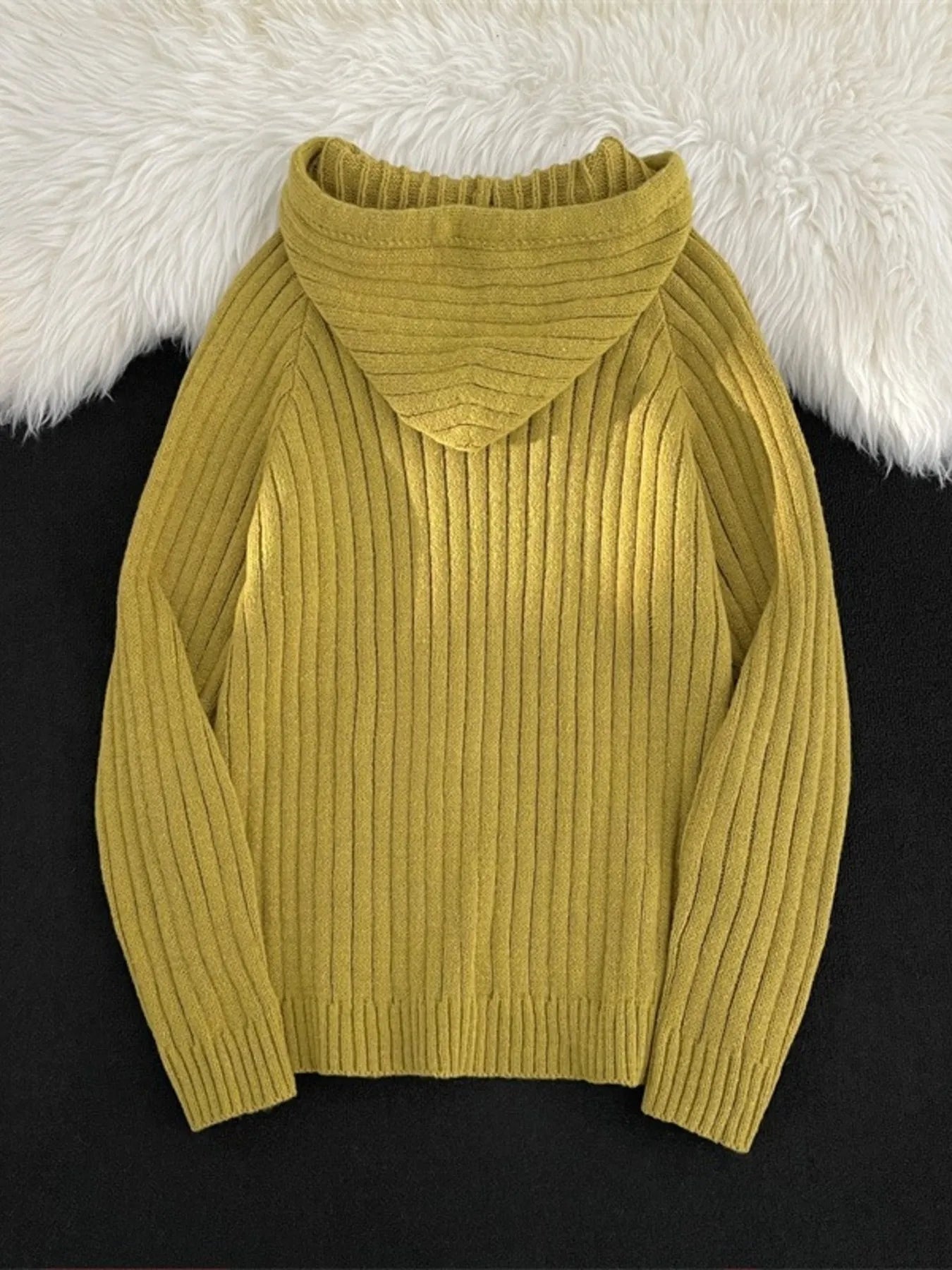 Yellow ribbed knit hooded sweater with a cowl neck and long sleeves.
