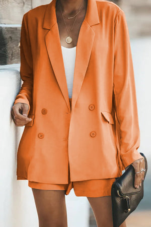 Orange double-breasted blazer and pleated shorts set with button details.