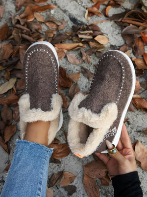 Felted shearling slippers in chocolate brown with white stitch detail and fluffy trim.