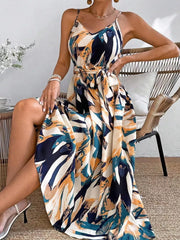 Belted cami maxi dress with a vibrant abstract print in navy, teal, and orange.
