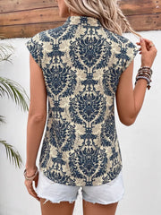 Ornate cap sleeve blouse with notch neckline in a blue and beige damask print.