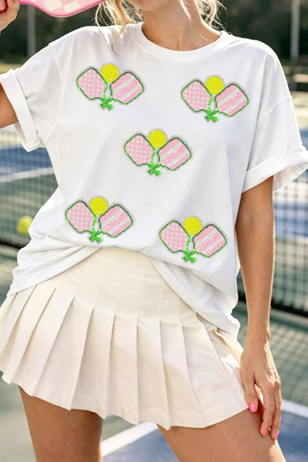 White cotton t-shirt with playful sequin pickleball applique, crew neck, short sleeves.