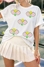 White cotton t-shirt with playful sequin pickleball applique, crew neck, short sleeves.