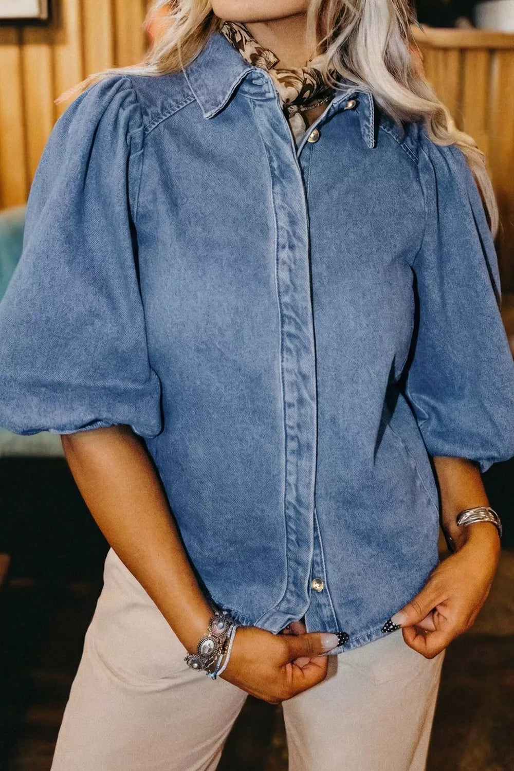 Denim maternity blouse with voluminous puff sleeves, collared neckline, and button-down front.