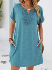 Dusty blue V-neck pocket dress with lace trim and cuffed short sleeves.