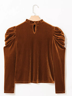 Brown velvet mock neck blouse with ruffled collar and gathered puff sleeves.