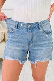 Light wash denim shorts with raw hem and distressed details
