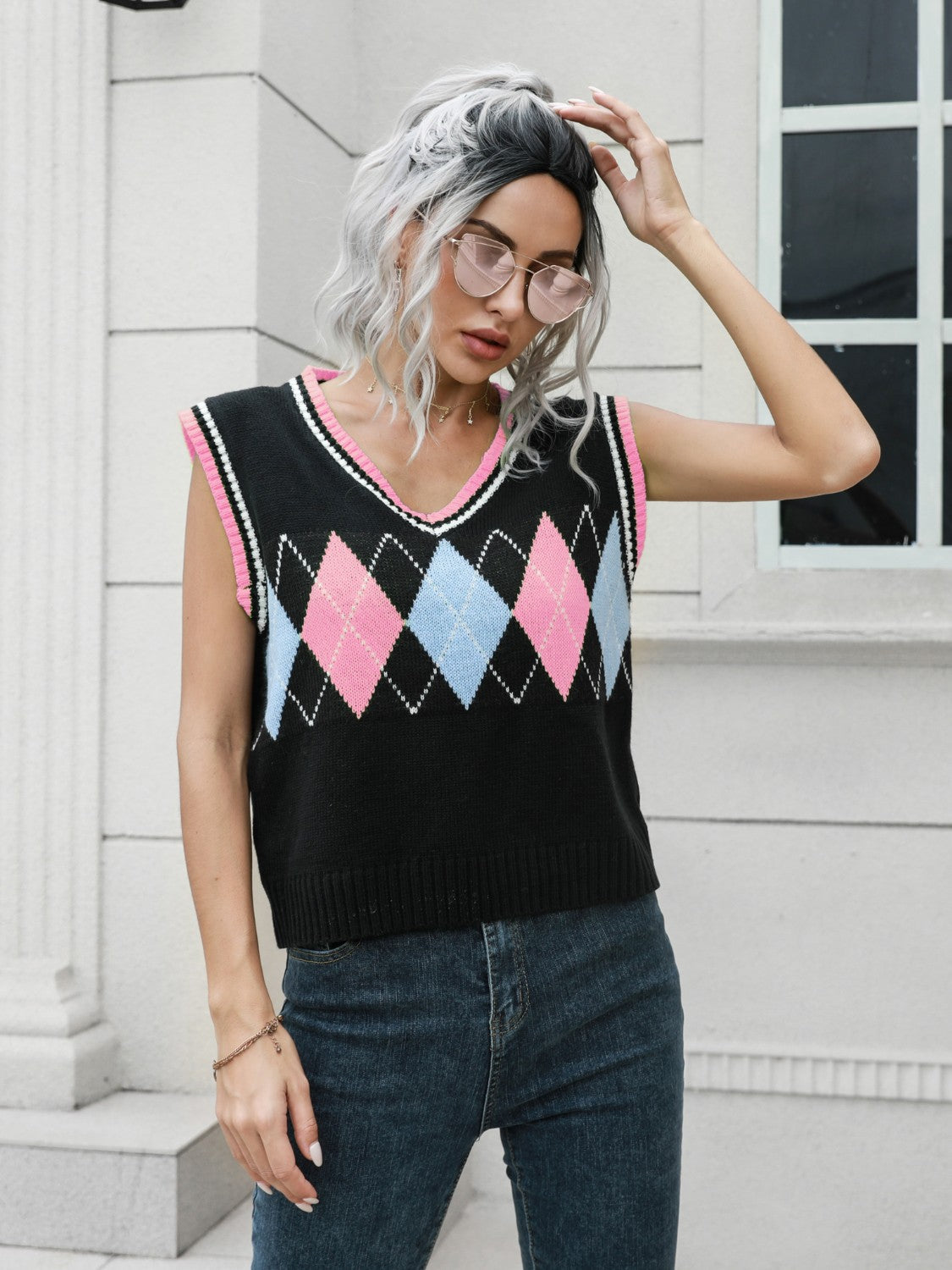 Argyle sweater vest in black with pink and blue diamonds, pink trim, V-neck, sleeveless.