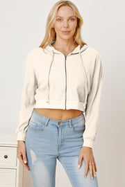 Waffle knit cropped zip hoodie in ivory with drawstring hood and full zipper.