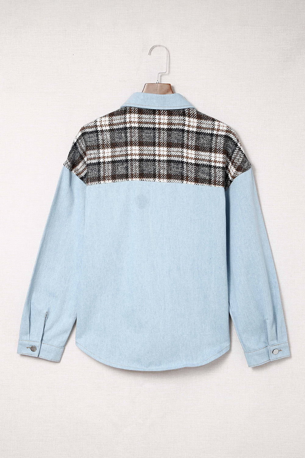Light blue denim shirt jacket with plaid panel detail on shoulders and back.