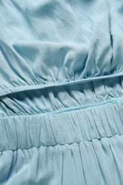 Light blue bandeau jumpsuit detail showing elasticated waist and textured fabric.
