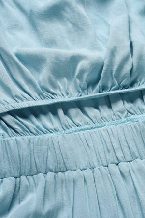 Light blue bandeau jumpsuit detail showing elasticated waist and textured fabric.