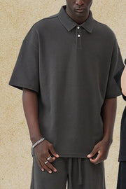 Dark Gray boxy textured polo shirt with short sleeves and a two-button placket.