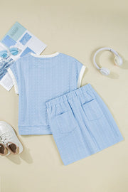 Light blue cable knit loungewear set with crew neck top and elastic waist shorts with pockets.