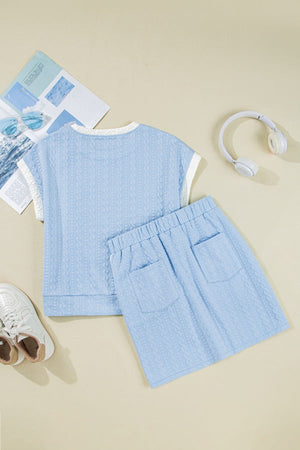 Light blue cable knit loungewear set with crew neck top and elastic waist shorts with pockets.
