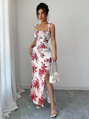 Floral print tie strap maxi dress in white with red flowers, ruched bodice, and thigh-high slit.