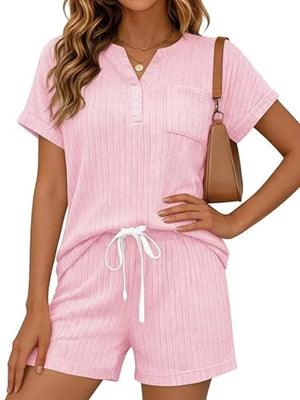 Pink ribbed knit loungewear set with henley neckline, chest pocket, and drawstring shorts.