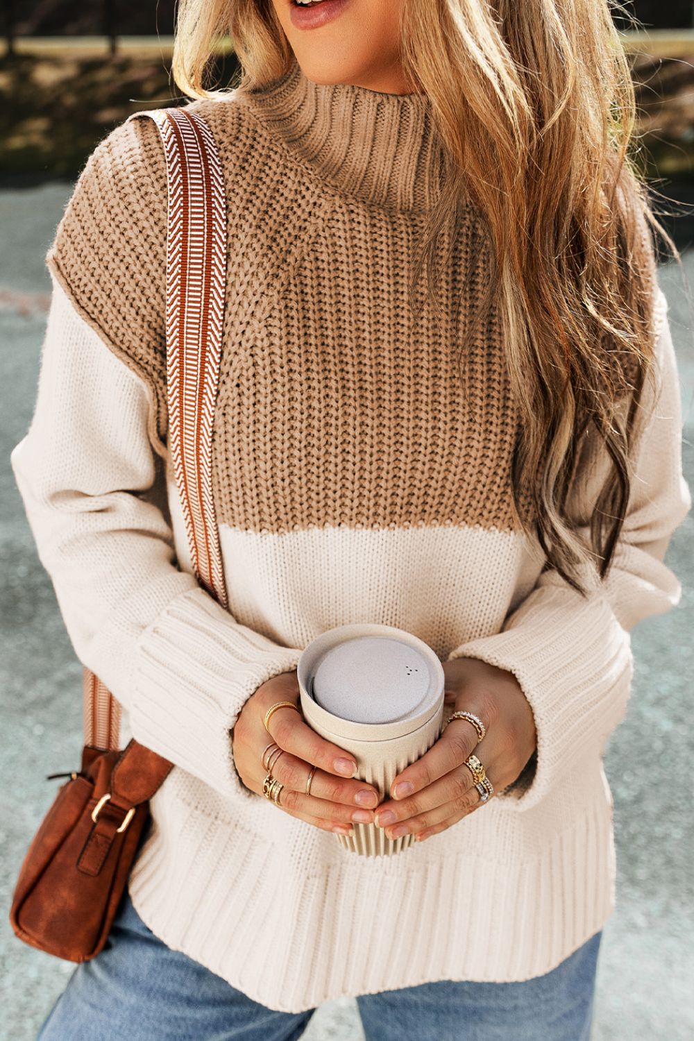 Colorblock ribbed turtleneck sweater in camel and cream acrylic with a side slit detail.