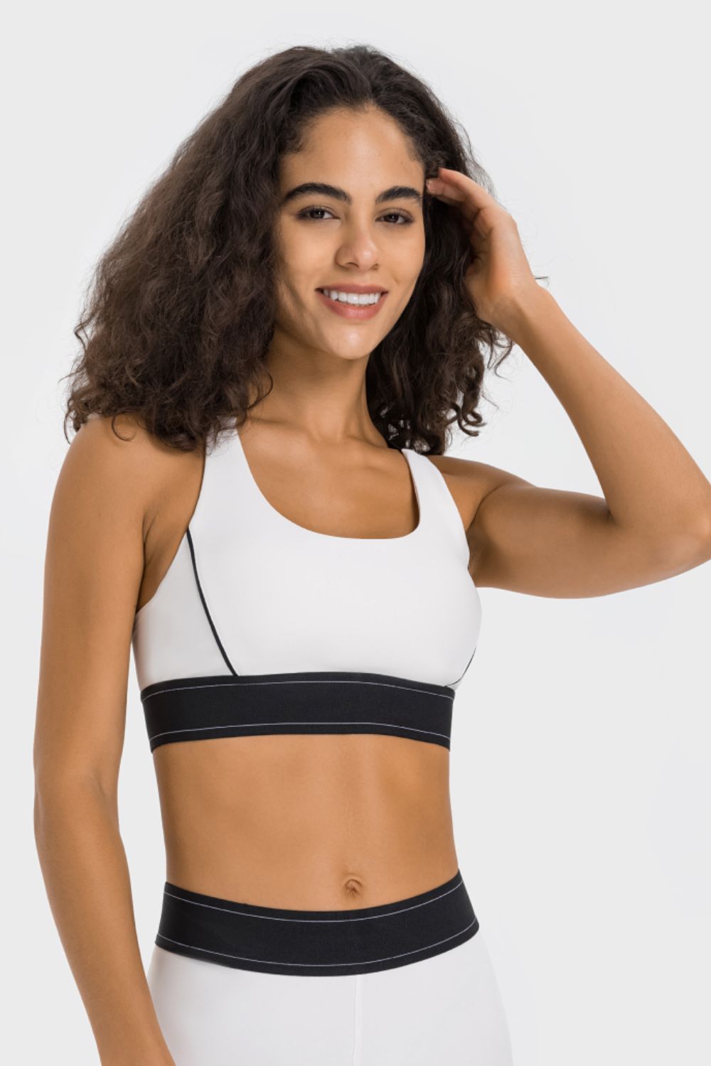 White sports bra with black trim and band, scoop neck, racerback detail