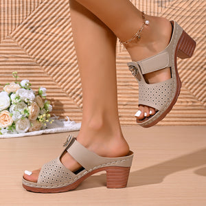 Khaki floral cutout block heel sandals with perforated details and adjustable strap.