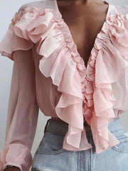 Pink chiffon ruffle plunge blouse with sheer sleeves and ruffled neckline.