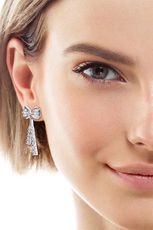 Silver baguette bow drop earrings with cascading crystal fringe detail.