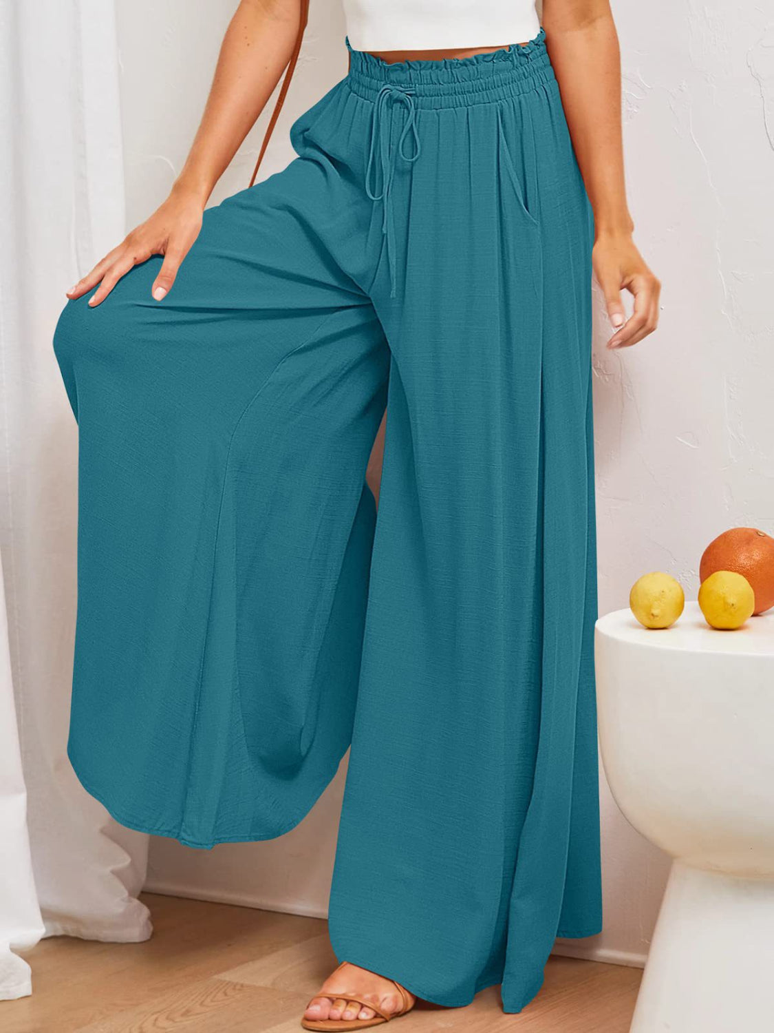 Textured drawstring palazzo trousers in Deep Teal with pockets and wide legs.