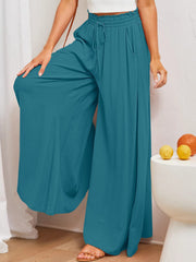 Textured drawstring palazzo trousers in Deep Teal with pockets and wide legs.