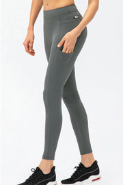 Dark gray athletic leggings with utility pockets and a zippered back pocket.