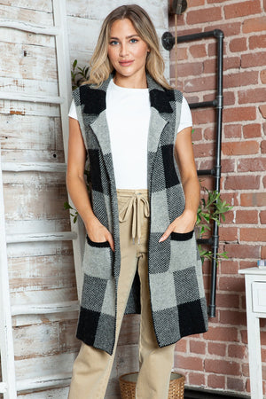 Geometric knit duster vest in black and tan checkered pattern with pockets.