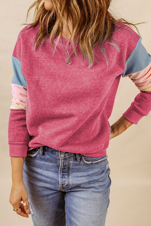 Chic Color Pop Pullover in Dusty Pink with colorblock sleeves and crewneck, styled with jeans.