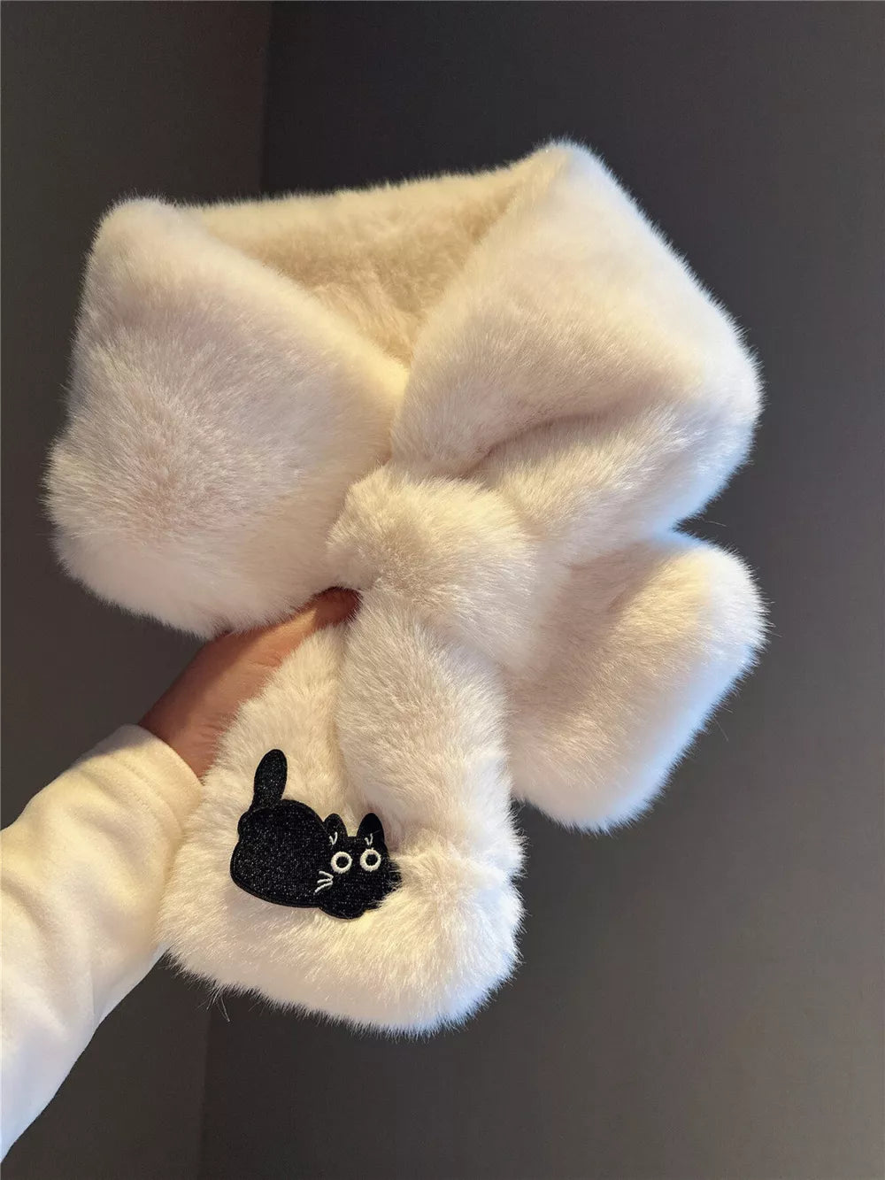 Cream plush scarf with a black cat embroidery detail.